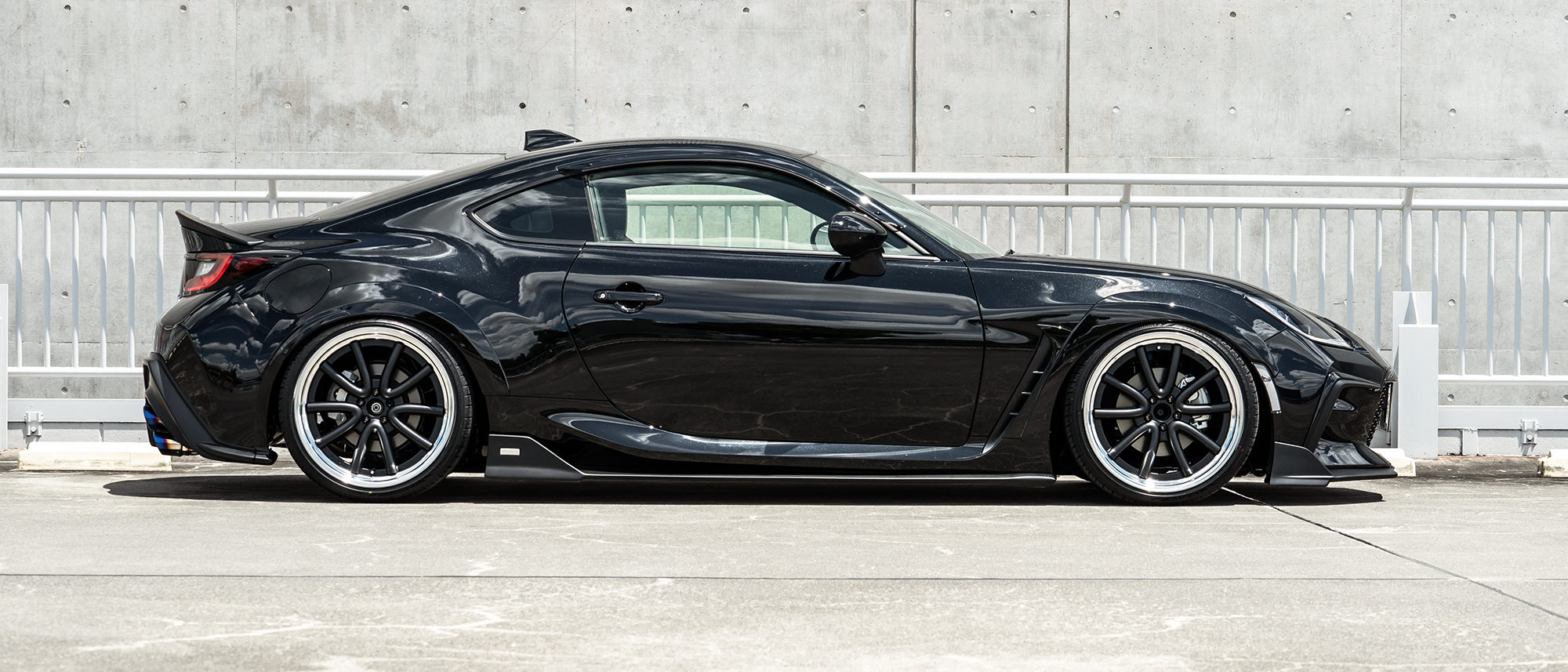 Black Toyota GR86 side profile fitted with WALD Octopus Racing wheels