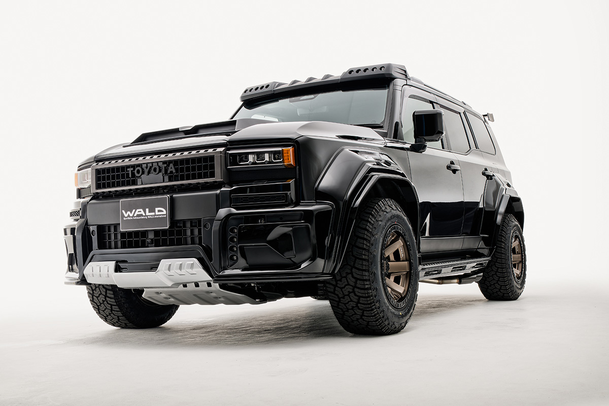WALD Black Bison Land Cruiser 250 Prado front three-quarter studio view with silver skid plate and bronze WALD wheels