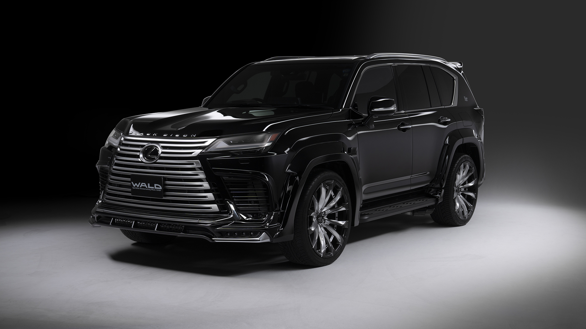 WALD Black Bison Edition Lexus LX600 LX700h VJA VJH310W — black LX600 front three-quarter studio view with WALD front spoiler and wide arch package