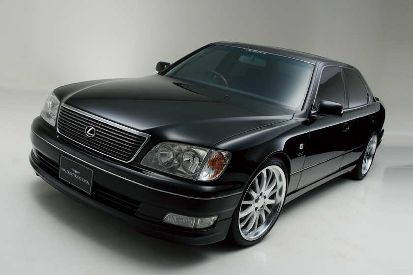 WALD Executive Line Toyota Celsior UCF20/21 — black Celsior front three-quarter studio view with WALD front spoiler and multi-spoke wheels