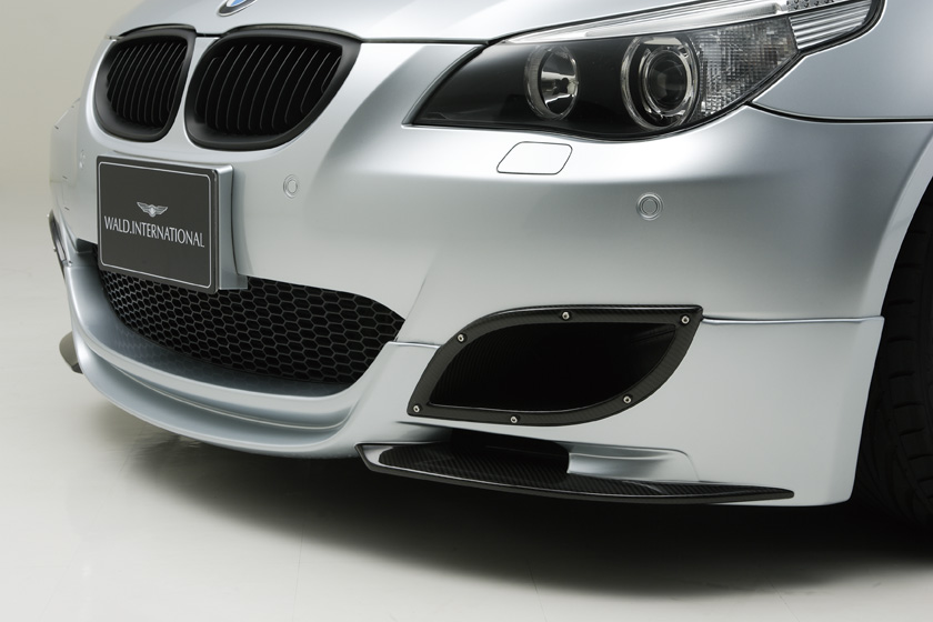 WALD BMW M5 E60 front bumper detail showing WALD lip spoiler and carbon air intake trim
