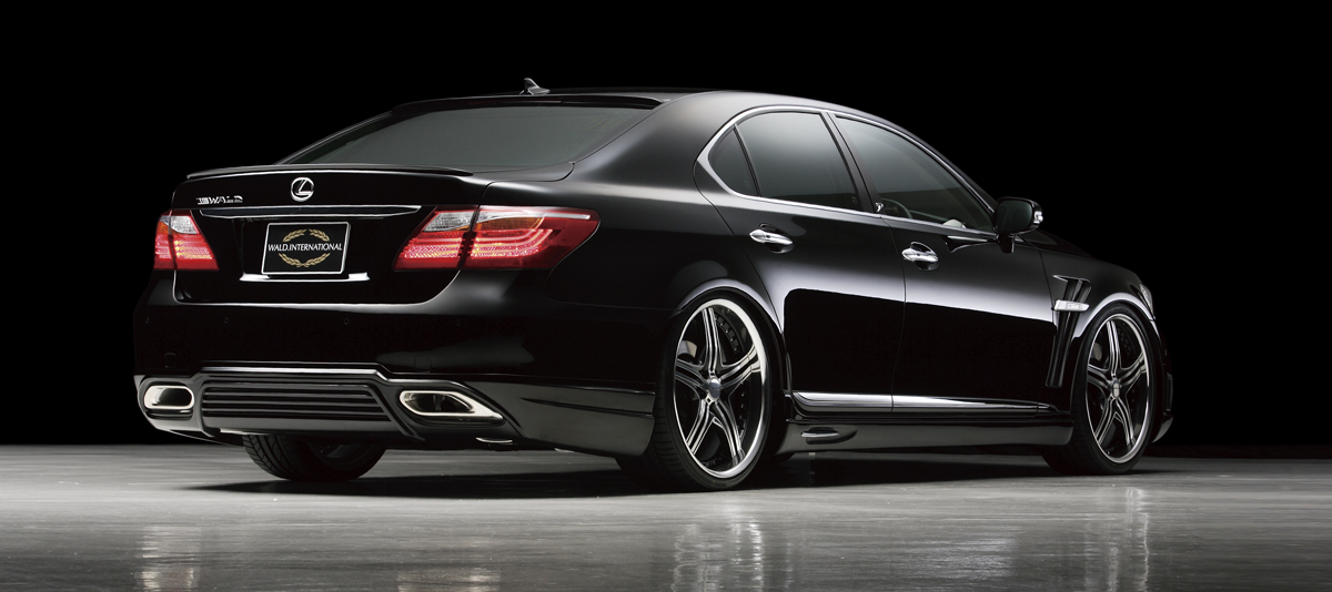 WALD Executive Line Lexus LS460L rear three-quarter studio view with WALD rear skirt, boot spoiler and exhaust finishers
