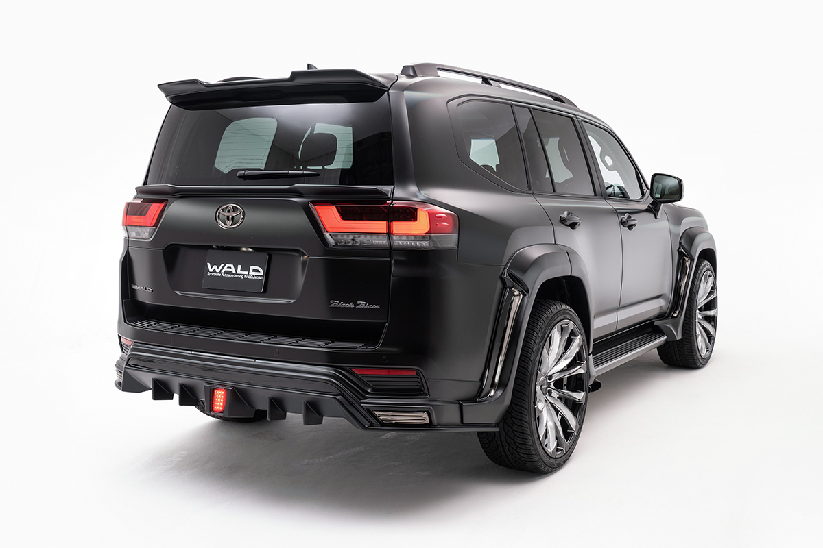 WALD Black Bison Land Cruiser 300 rear three-quarter view with rear skirt and tailgate spoiler