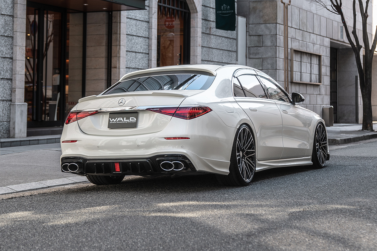White Mercedes S-Class W223 rear three-quarter view with WALD rear skirt and boot spoiler