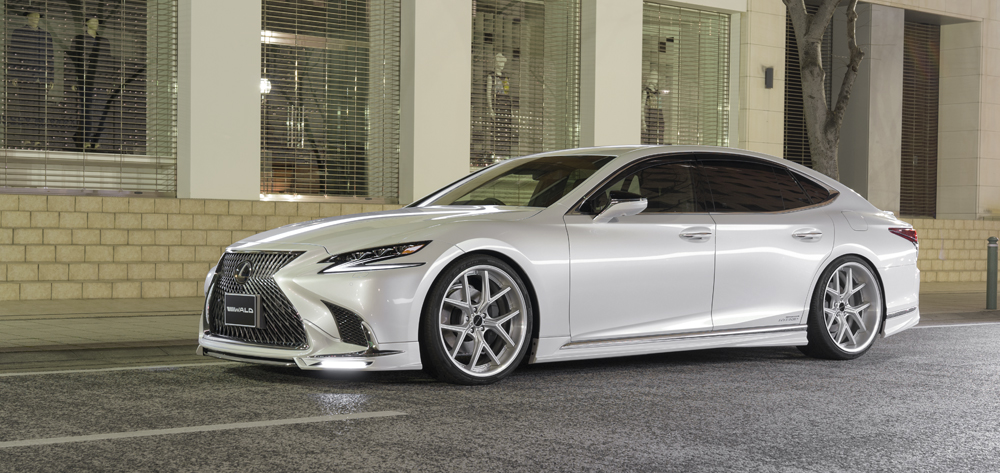 WALD Lexus LS500 Executive Version L in white front three-quarter night view with LED-lit WALD front spoiler