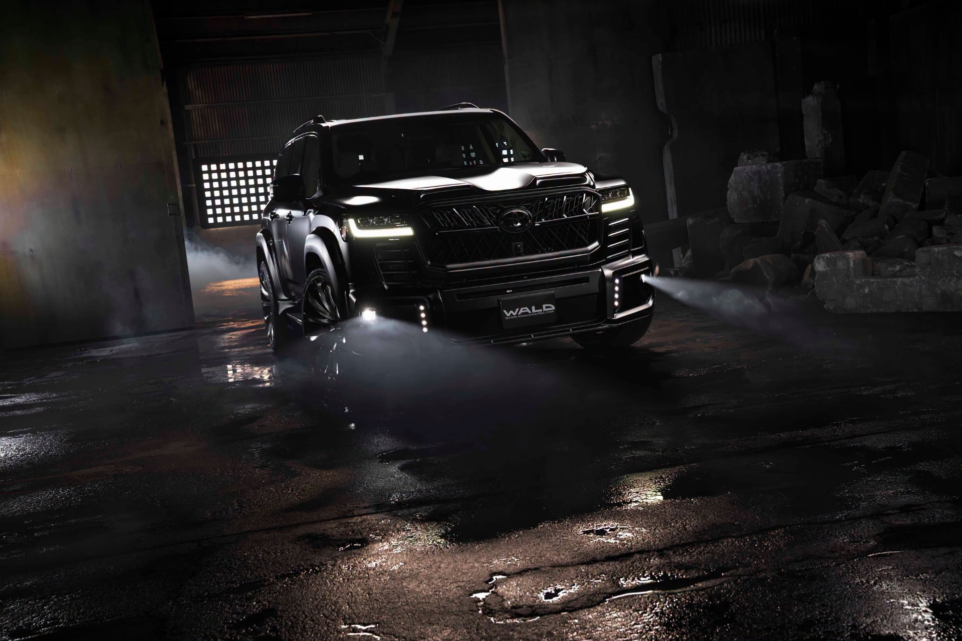 WALD Black Bison Land Cruiser 300 ZX front three-quarter night view with wide arch package and 24-inch WALD wheels