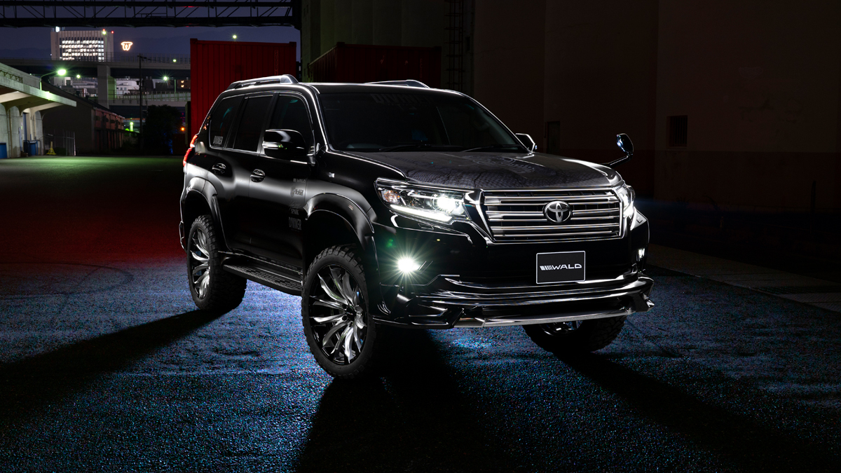 Black WALD Sports Line Prado 150 front view at night with lights illuminated