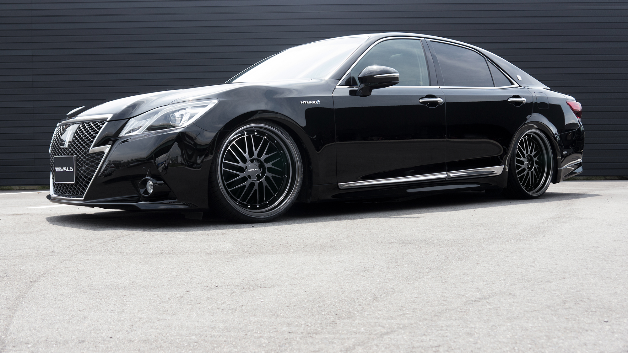 Black Toyota Crown Hybrid with WALD aero on black TOSCA II T22-C multi-piece wheels