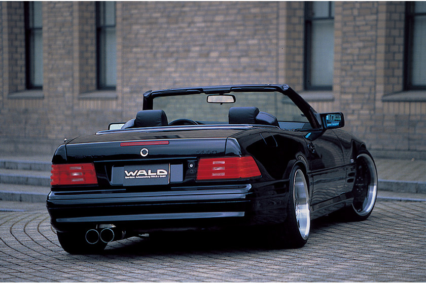 WALD Executive Line Mercedes-Benz SL-Class R129 roadster rear three-quarter view with roof down and twin exhaust tips