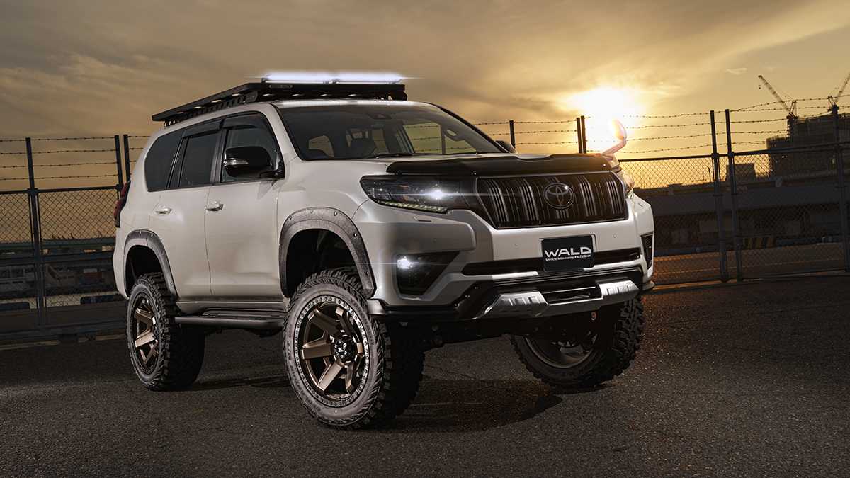 WALD Desert Line Toyota Land Cruiser Prado at sunset with LED roof light bar illuminated