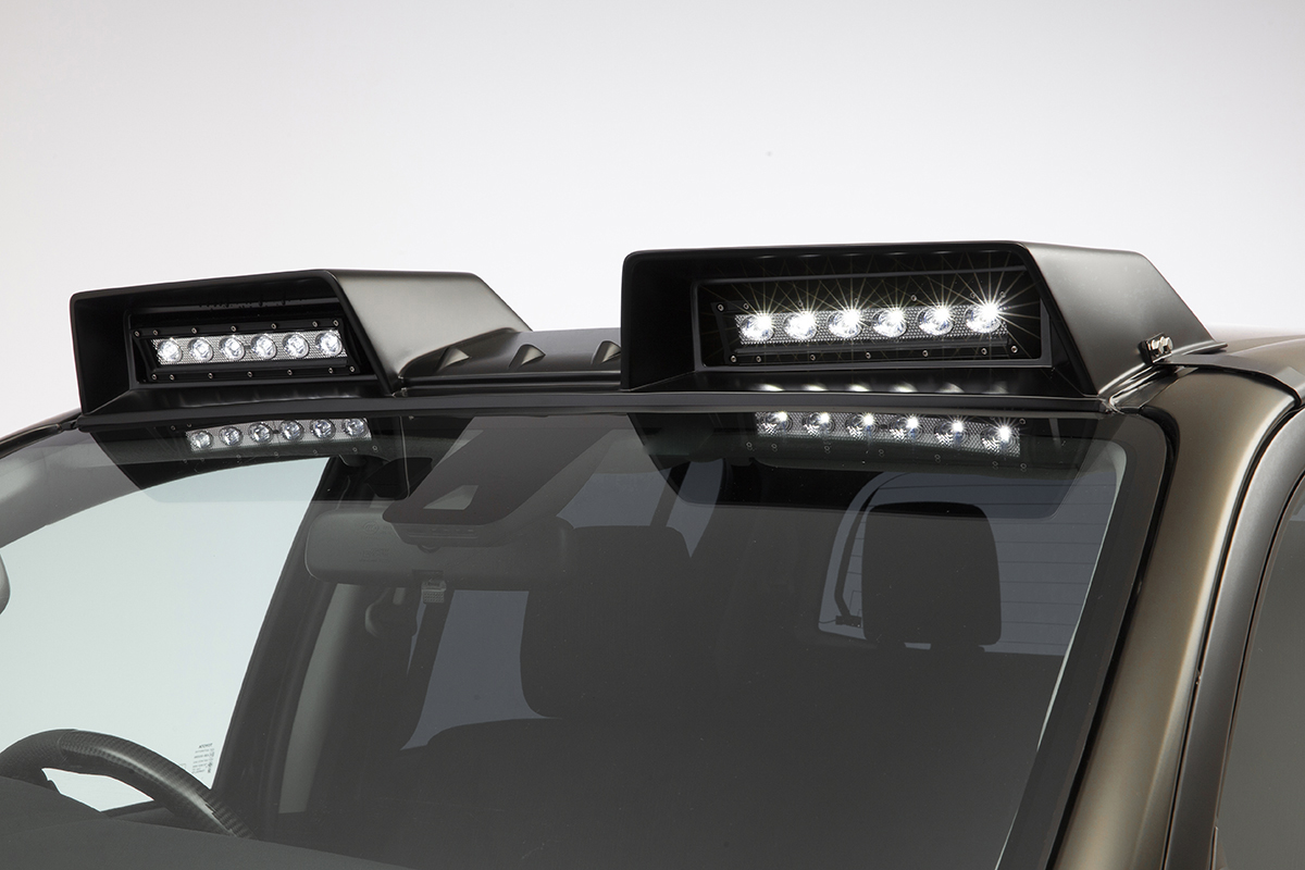 WALD Black Bison front roof spoiler with twin LED light bars illuminated on the Toyota Hilux GUN125 facelift