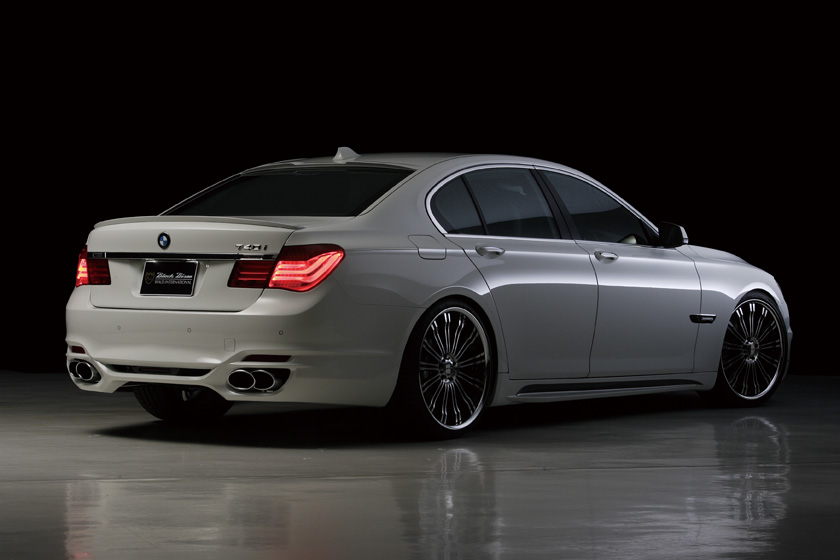 WALD BMW 7 Series F01 Black Bison rear three-quarter view showing WALD rear bumper spoiler and twin 240 stainless steel exhaust tips