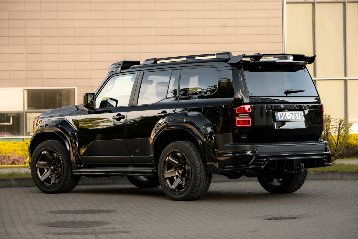 WALD Black Bison Land Cruiser 250 Prado rear three-quarter view with rear skirt and roof spoilers
