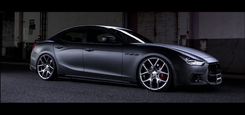 Matte grey Maserati Ghibli on WALD ILLIMA I11C wheels in a dark industrial setting