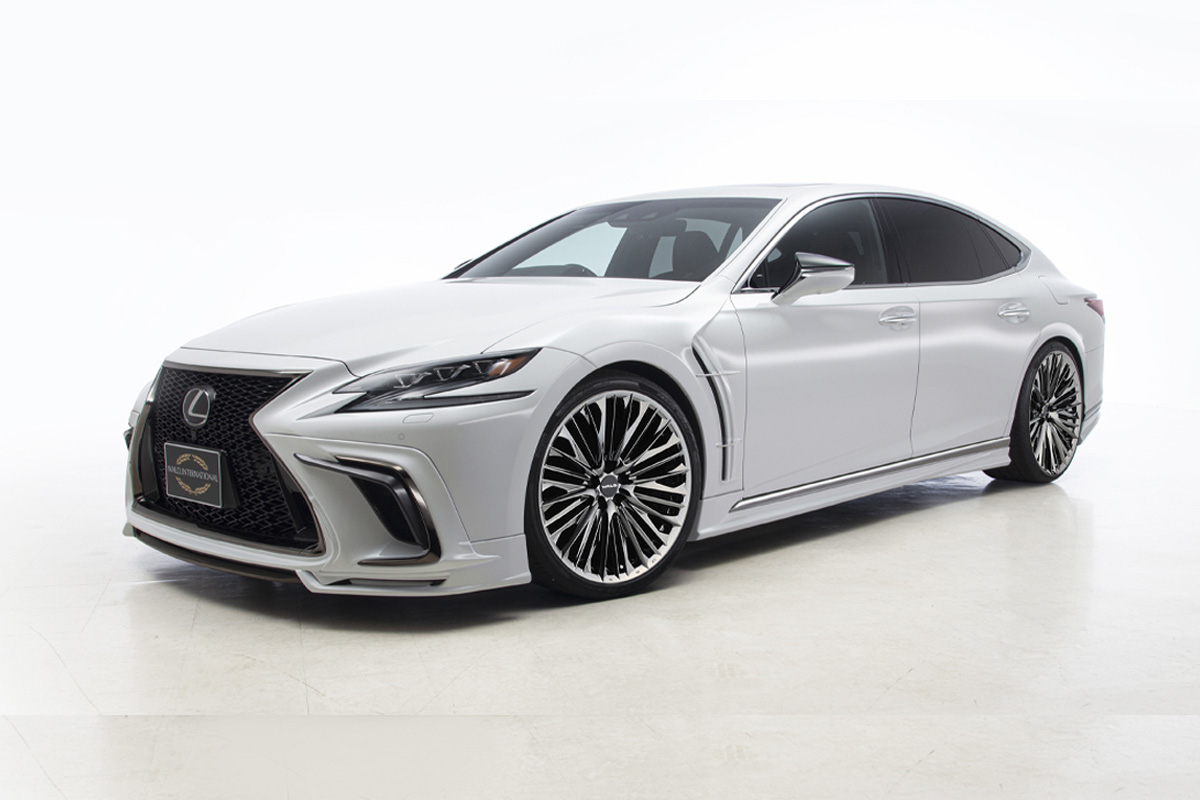 Silver Lexus LS with WALD body kit and Genuine Line F-001 SBC Super Black Coat wheels, studio front three-quarter view