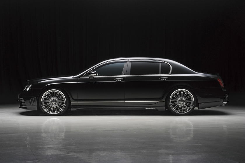 WALD Bentley Continental Flying Spur body kit — full side profile studio view showing lowered stance and Black Bison side skirts