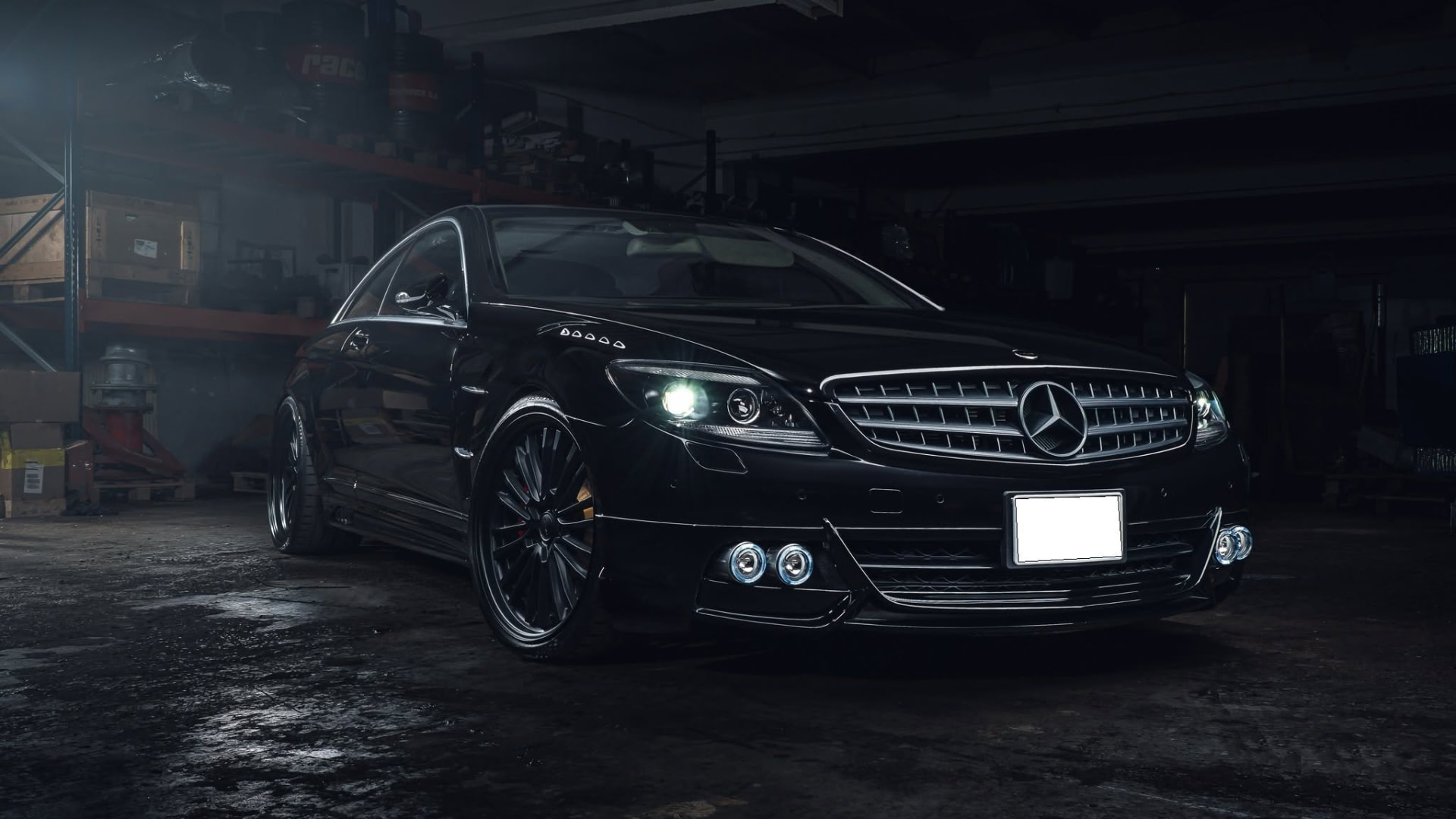 WALD Black Bison Mercedes-Benz CL C216 front three-quarter view in a workshop with multi-spoke WALD wheels