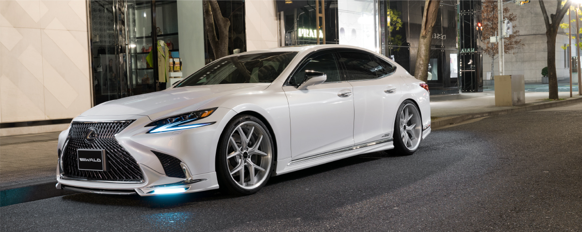 White Lexus LS 500h with WALD Sports Line kit on ILLIMA I 12F forged wheels in Hyper Silver