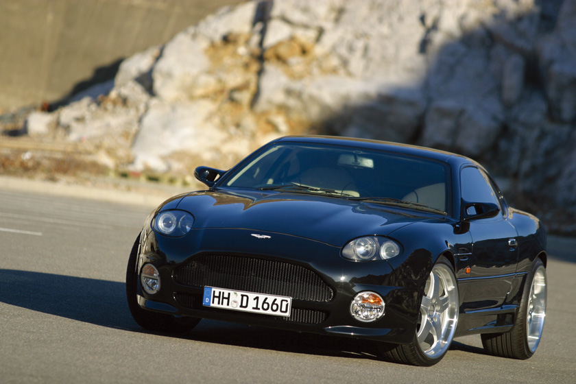WALD Aston Martin DB7 Sports Line — black DB7 front three-quarter on-road view with complete WALD body kit