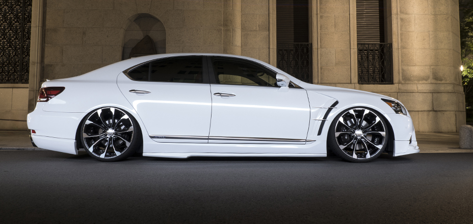 WALD Executive Line Lexus LS460 F SPORT in white lowered side profile at night on black polished WALD wheels