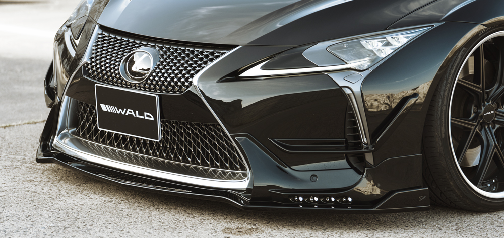 WALD Lexus LC500 front spoiler close-up with LED daytime running lamps and WALD plate
