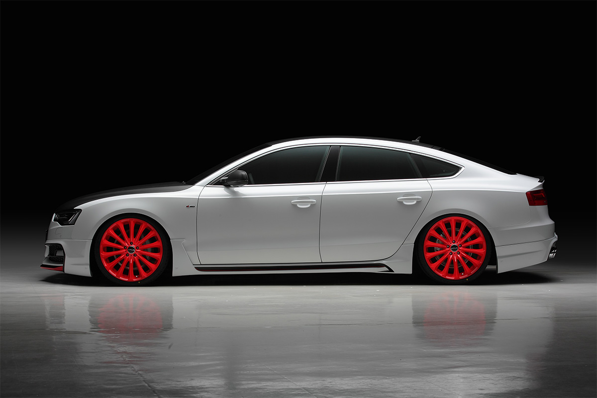 WALD Audi A5 Sportback S Line side profile — WALD Sports Line side skirts and red WALD wheels in studio lighting