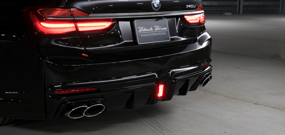WALD BMW 7 Series G12 Black Bison rear bumper detail — three-dimensional diffuser, LED lamp and twin 240 stainless steel exhaust tips