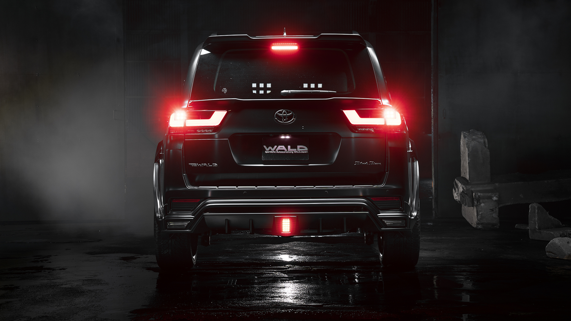 WALD Black Bison Land Cruiser 300 ZX rear view with tailgate spoiler, rear skirt and LED lamps