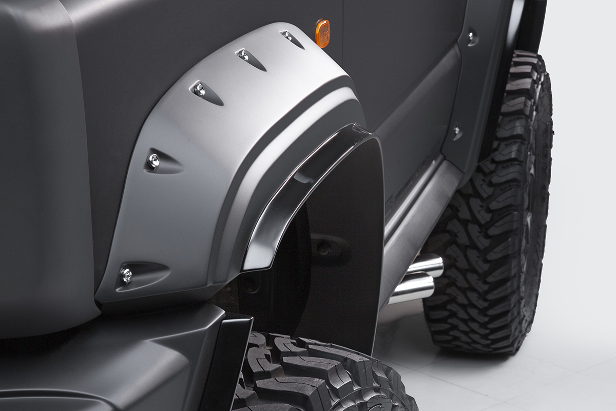 WALD Black Bison Edition Suzuki Jimny Sierra JB74W — studio detail of the front wide arch package, side skirt and side exit exhaust tip