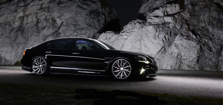WALD Executive Line Lexus LS460L side profile at night against rock face on polished WALD wheels
