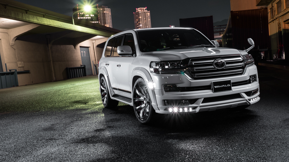 WALD Sports Line Land Cruiser 200 in white at night — front three-quarter with wide arch package and JARRET 24-inch wheels