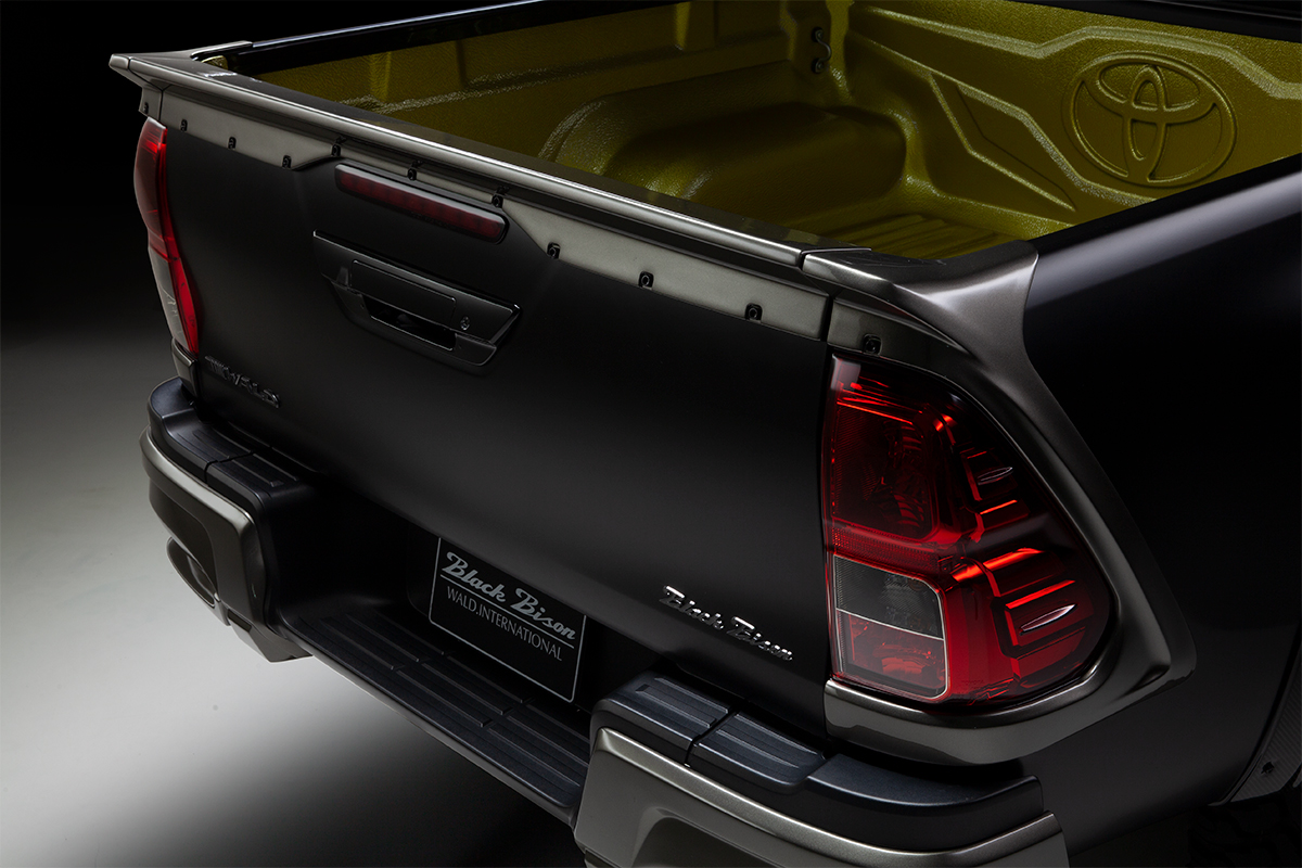 WALD Black Bison tailgate spoiler and Black Bison lettering on the black Toyota Hilux GUN125 rear