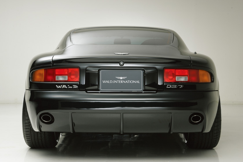WALD Aston Martin DB7 conversion — rear view of black DB7 with WALD rear bumper spoiler and twin exhaust outlets