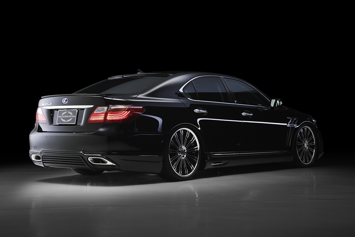 WALD Executive Line Lexus LS600h rear three-quarter studio view with WALD rear skirt, boot spoiler and exhaust finishers