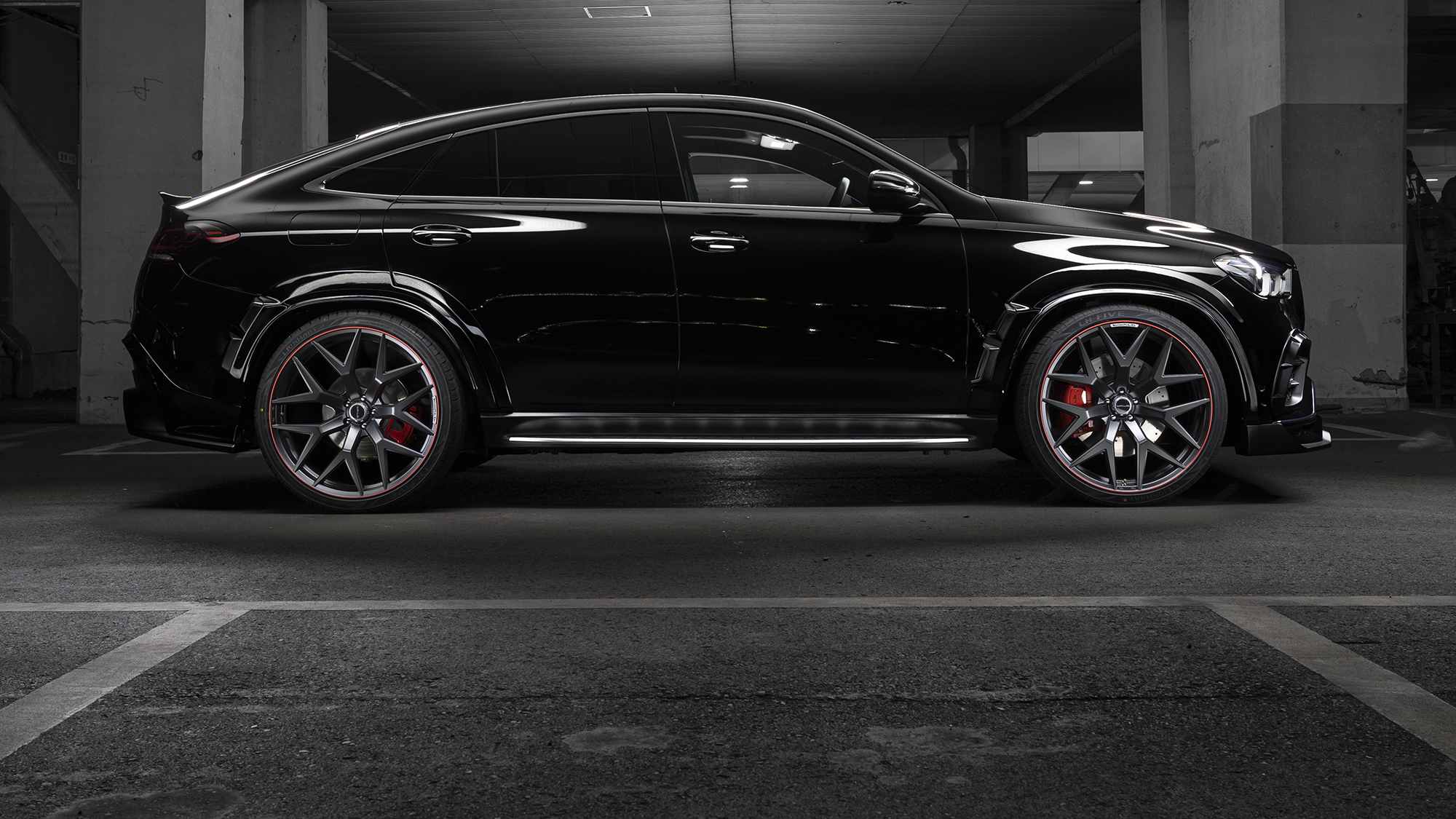 Side profile of a black Mercedes-Benz GLE Coupe on 24 inch WALD MB001 Matte Gunmetal Polish wheels