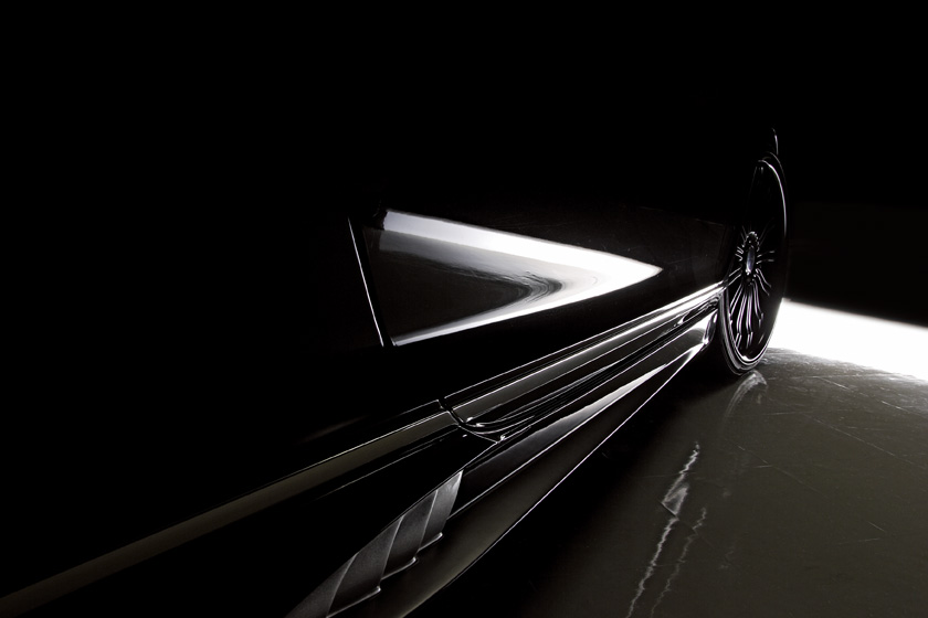 WALD Bentley Continental GT Black Bison side skirt detail lit against a dark studio background