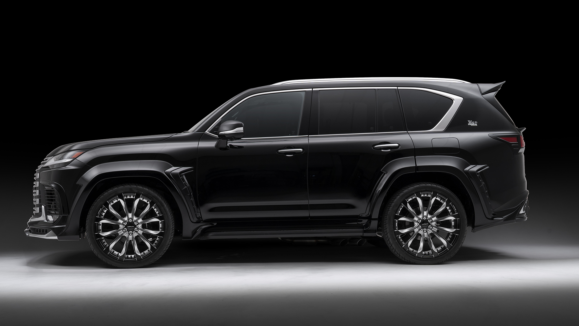 WALD Lexus LX700h Black Bison wide arch — side profile of a black LX showing the 12-piece wide arch package and side steps
