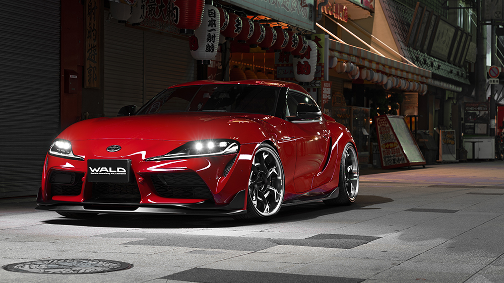 Red WALD Sports Line Toyota Supra DB## front three-quarter view on a Japanese street at night