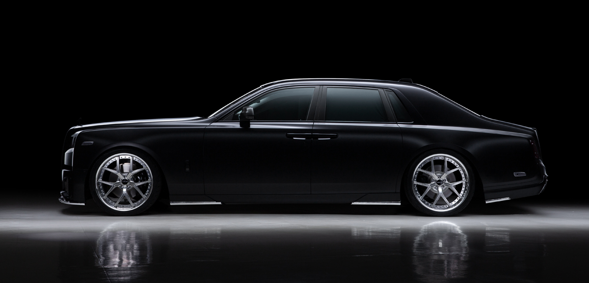Studio side profile of a black Rolls-Royce Phantom on polished WALD ILLIMA I13F forged wheels