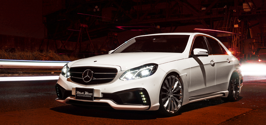 Mercedes-Benz E-Class W212 WALD Black Bison front styling at night with LED daytime running lamps
