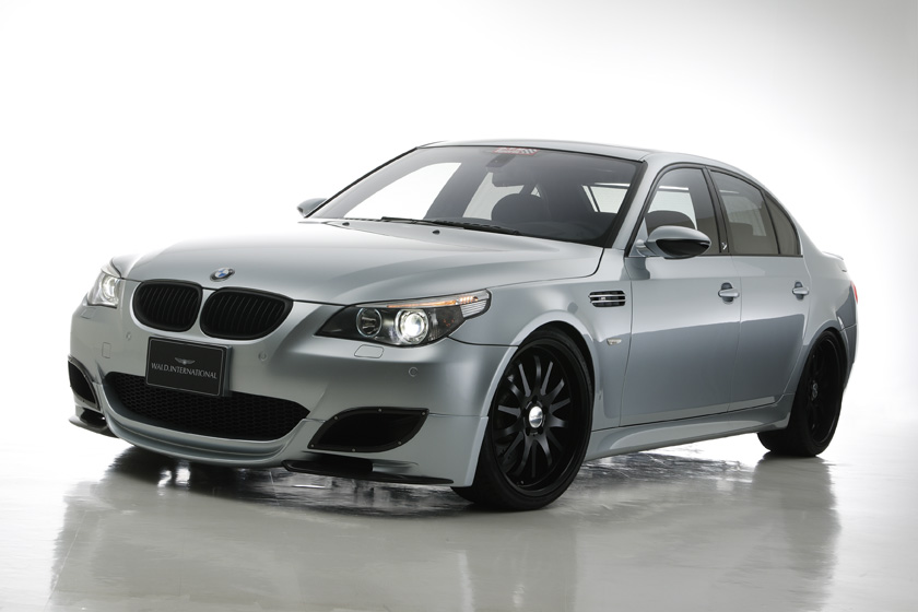 WALD BMW M5 E60 Sports Line body kit 2005–2011 — silver BMW M5 with WALD front lip spoiler, front three-quarter studio view