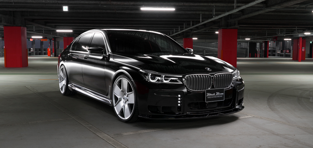 WALD BMW 7 Series G12 Black Bison black saloon front three-quarter view showing WALD front lip spoiler and side skirts