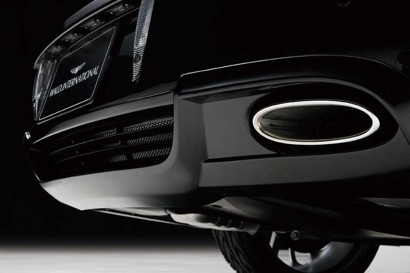 WALD Bentley Flying Spur Executive Line rear bumper and exhaust outlet detail under dark studio lighting