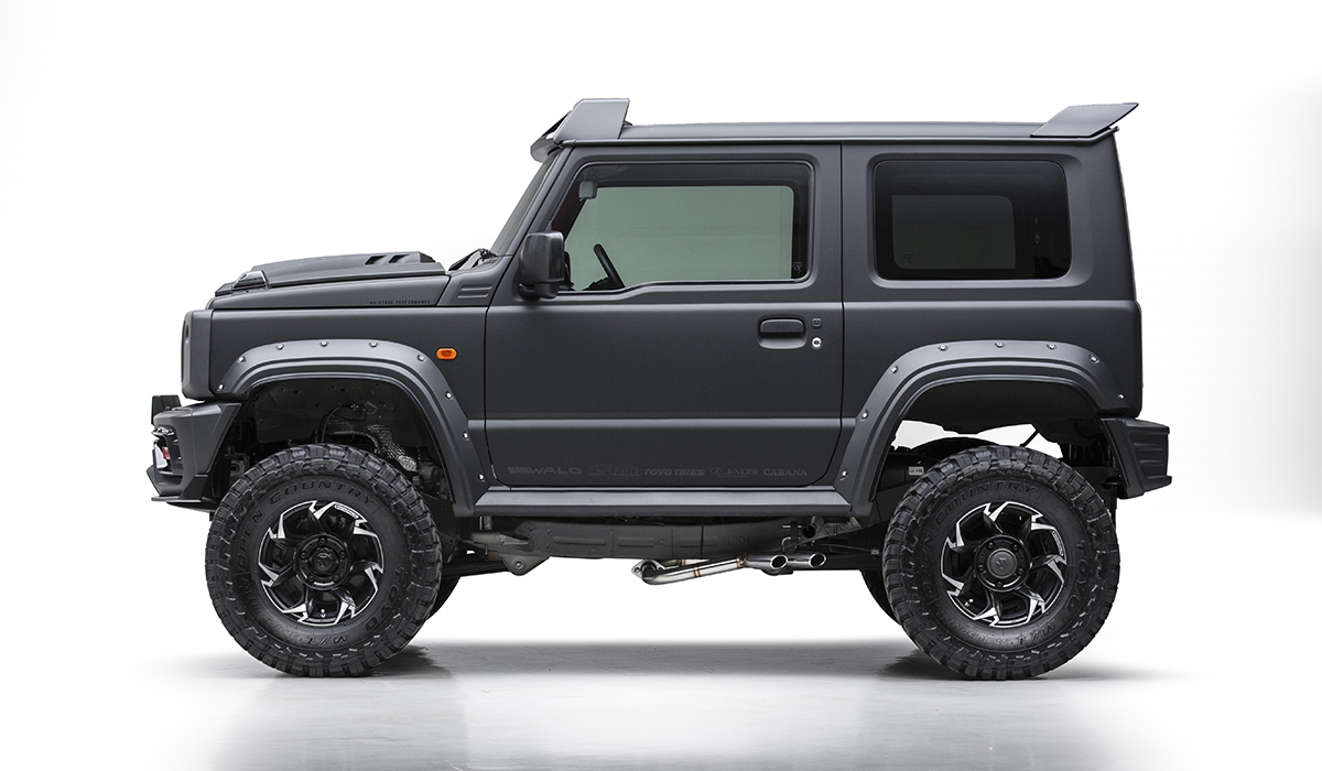 WALD Black Bison Edition Suzuki Jimny Sierra JB74W — full side profile studio view with wide arch package, decorative screws, side exit exhaust and rear wing