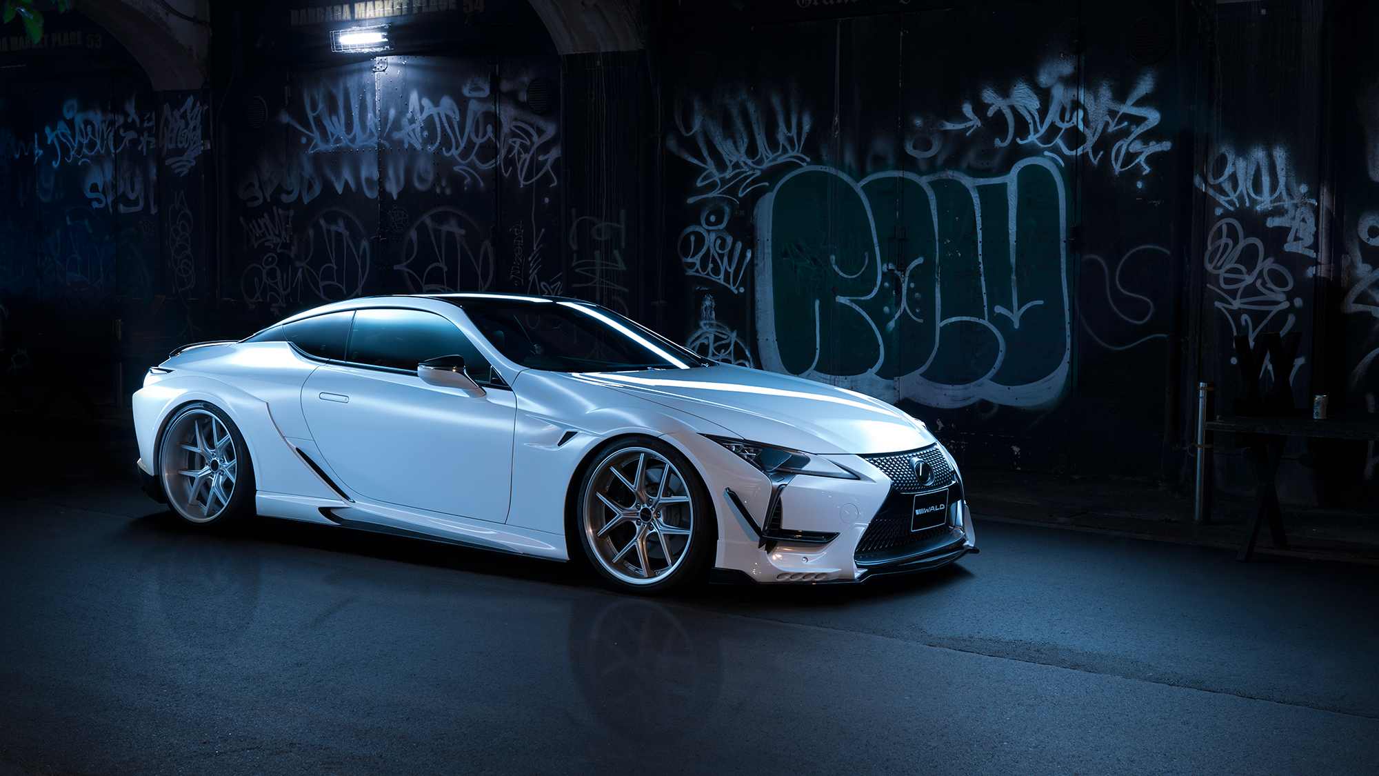 White Lexus LC coupe on ILLIMA I 12F forged wheels in Hyper Silver, side profile at night