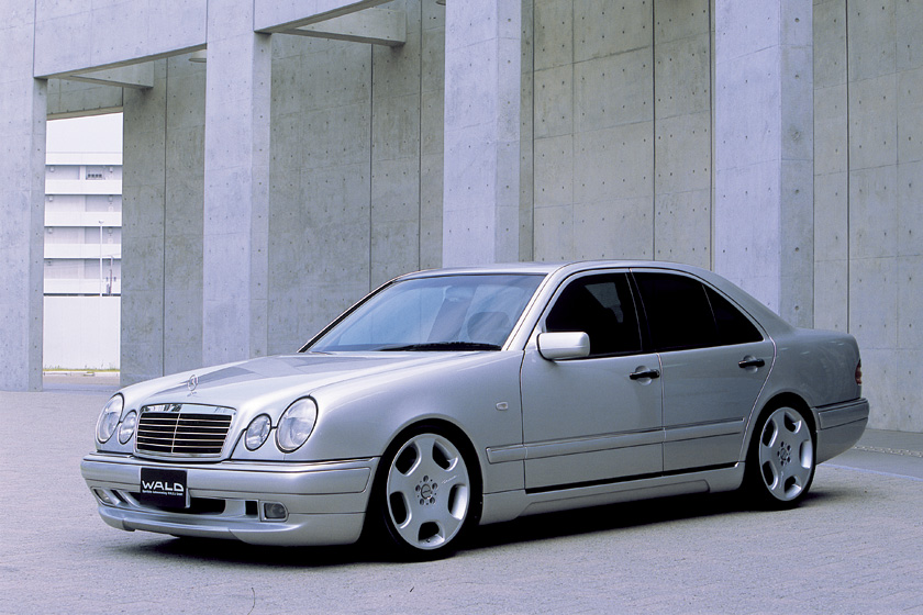 Mercedes-Benz E-Class W210 WALD Executive Line front three-quarter view against concrete architecture