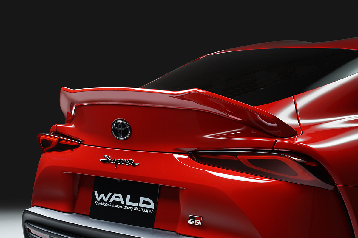 WALD boot spoiler detail on the red Toyota Supra DB## rear deck