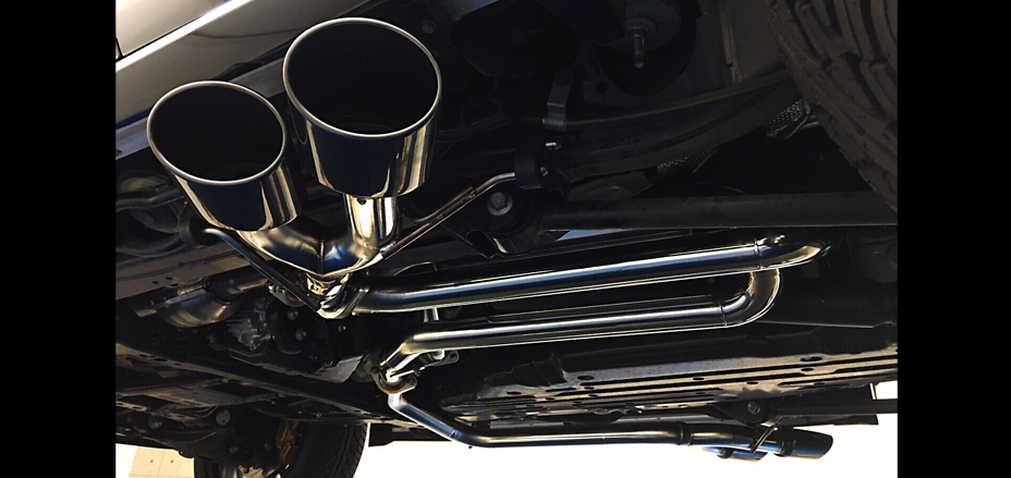 Underbody view of the WALD Lexus LX570 stainless steel exhaust system and dual tailpipes