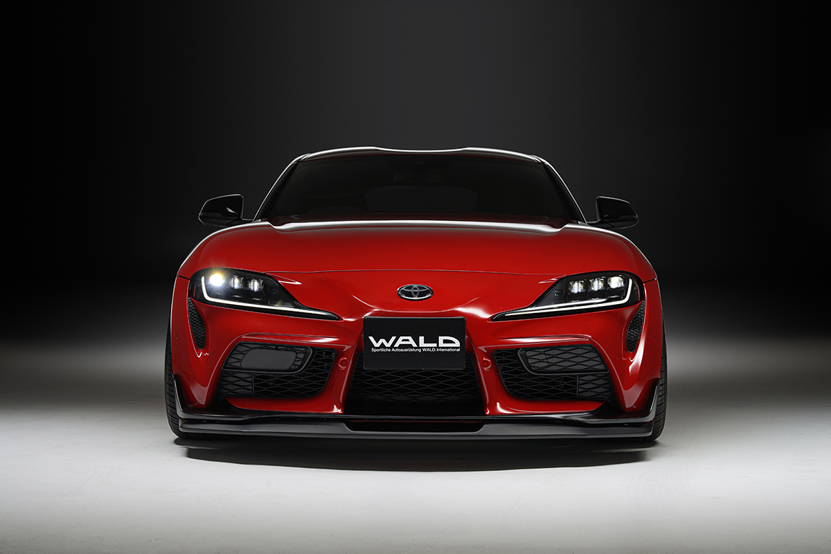 WALD Sports Line Toyota Supra head-on front view with illuminated headlights and front lip spoiler