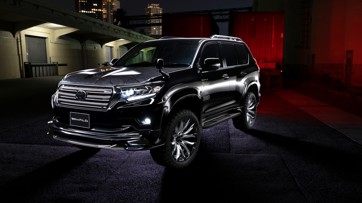 Black WALD Sports Line Prado 150 photographed at night under red lighting